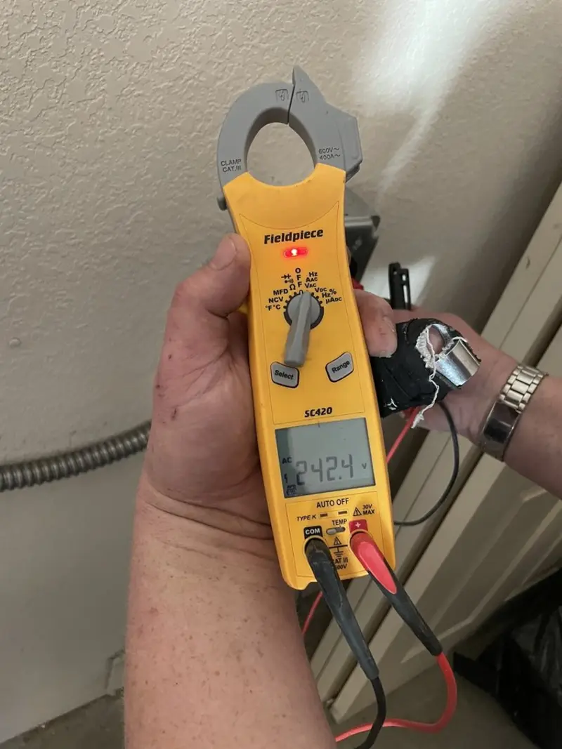 Voltage testing with clamp meter during Electrical Installation Services in West Lealman